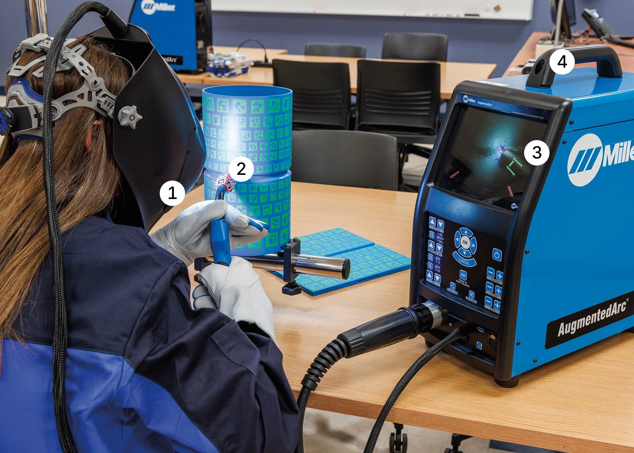 A person testing a welding simulator with augmented reality features, showcasing detailed equipment and a screen display.